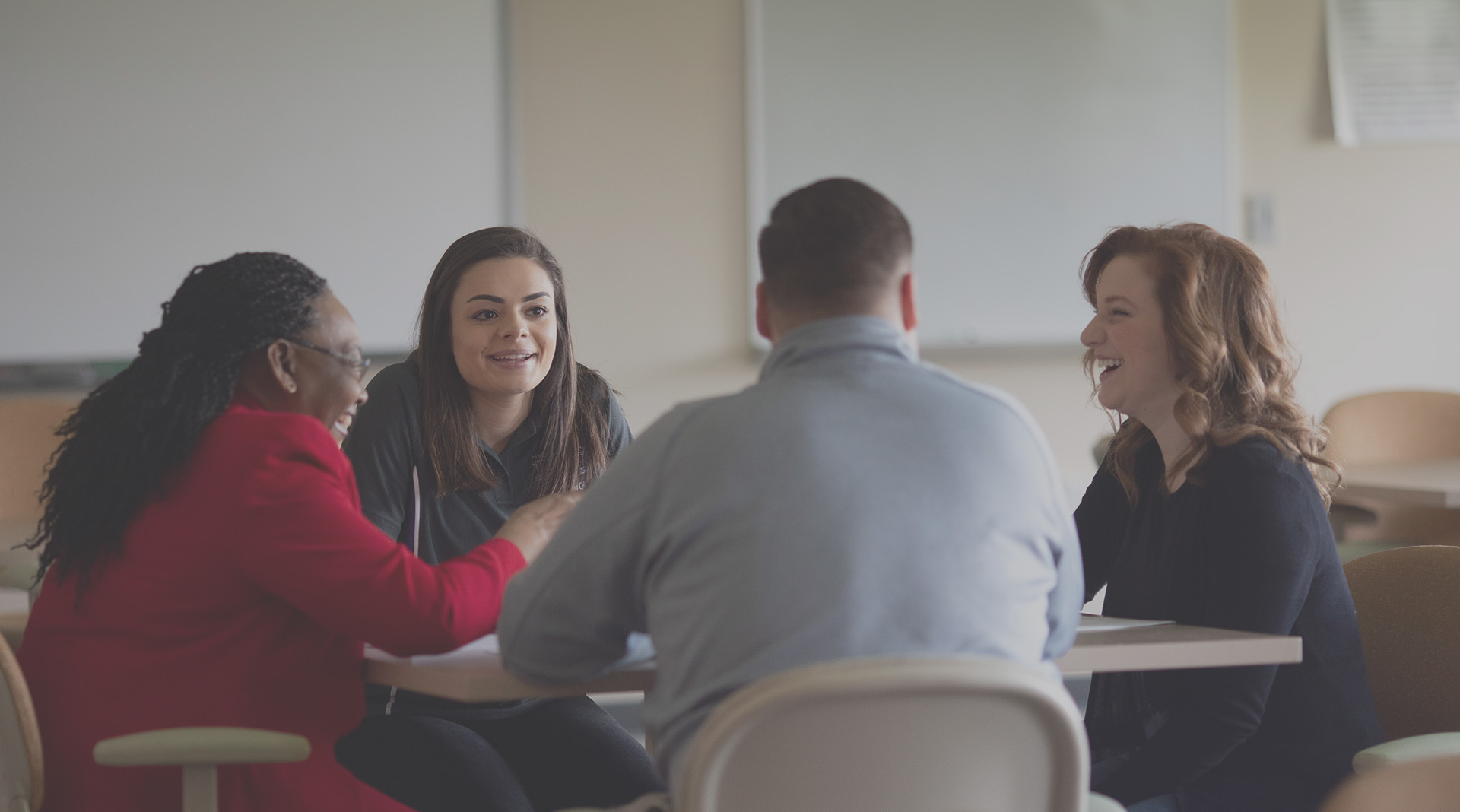 Education students in discussion with professor
